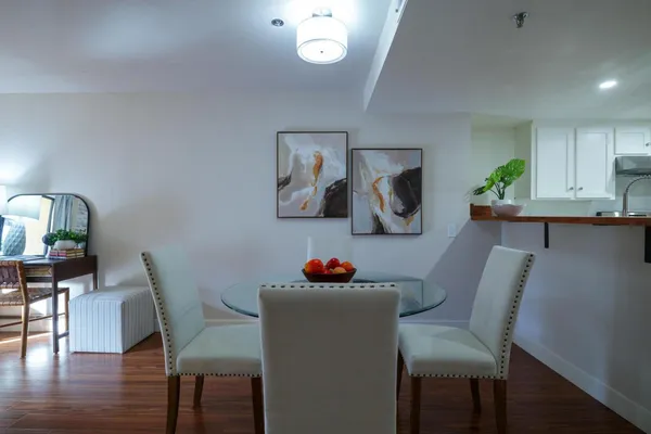 a dining room with furniture and a potted plant
