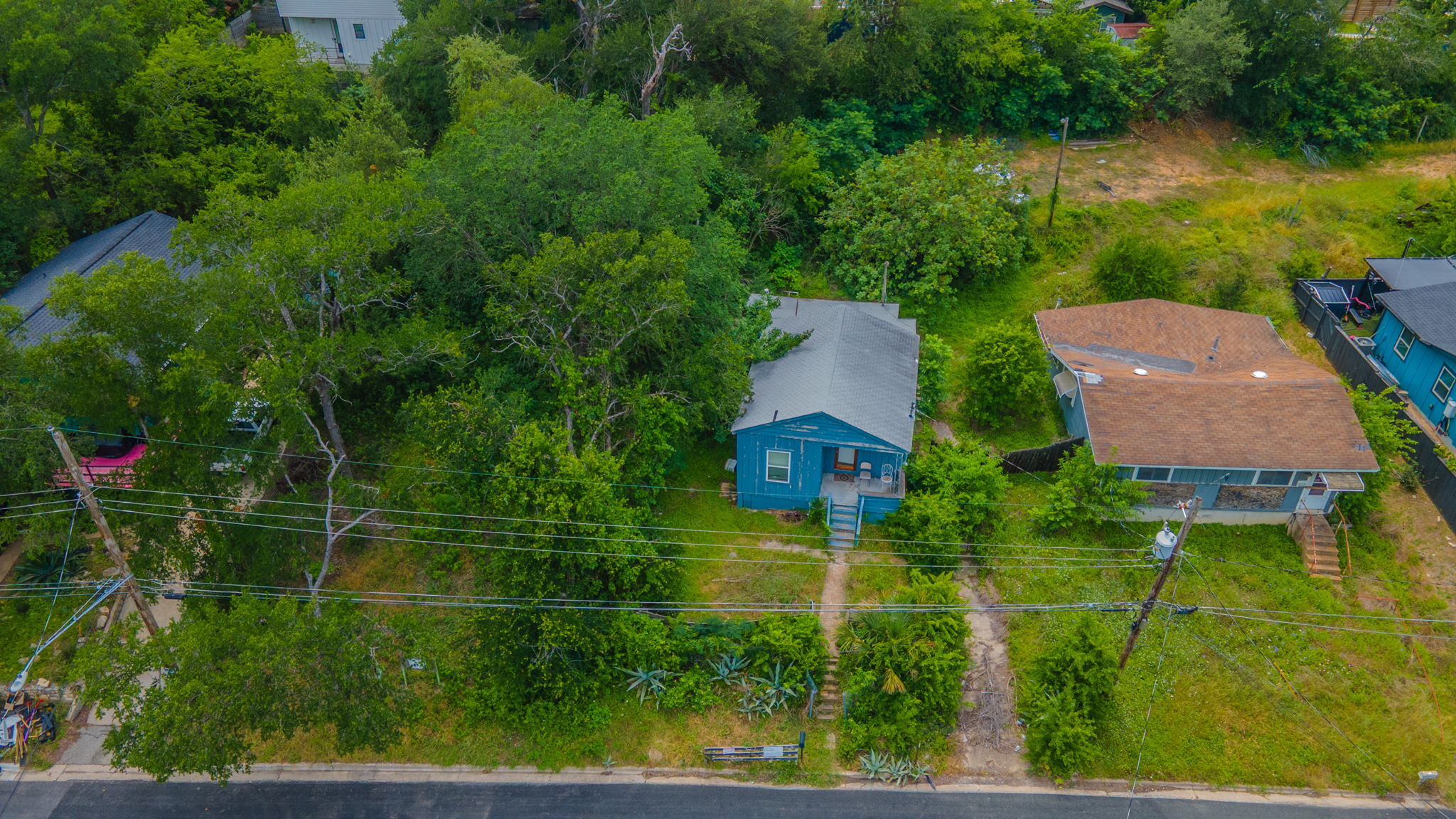 1408 Luna Street Austin, TX 78721 - Photo 2 of 5 An aerial perspective reveals a cozy home nestled amongst mature trees, offering ample potential for outdoor living.