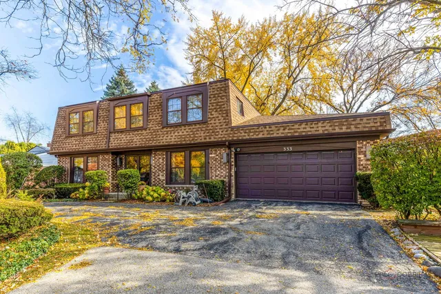 a front view of a building with a garden