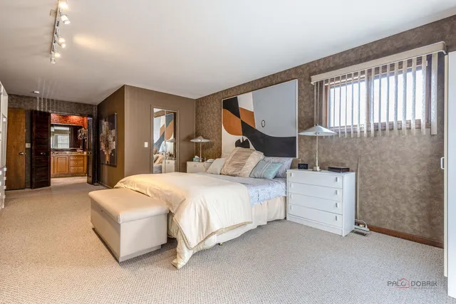 a bedroom with bed and window