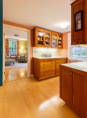 a view of a kitchen with a sink and a large window