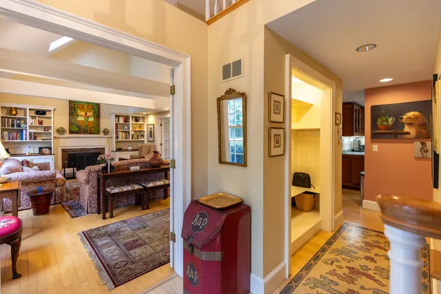 a living room with fireplace furniture and a rug