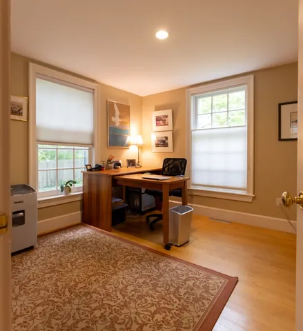 a living room with furniture rug and a window