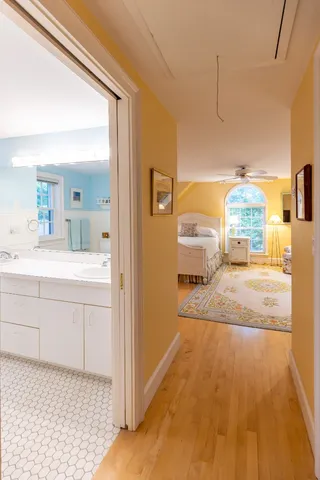 a bathroom with a sink a mirror and a bath tub