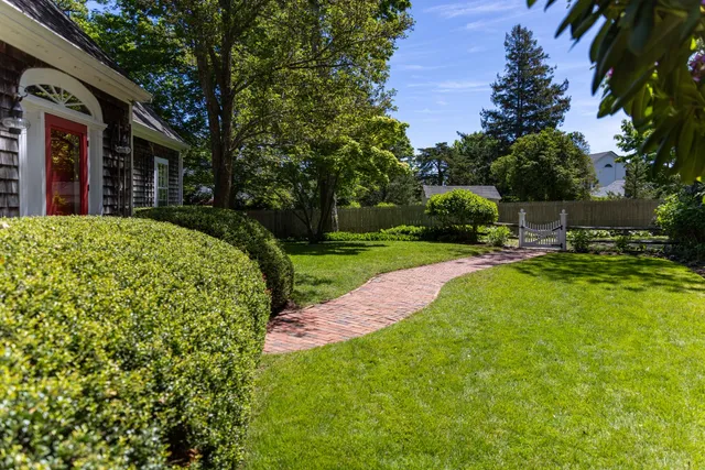 a view of a house with backyard and sitting area