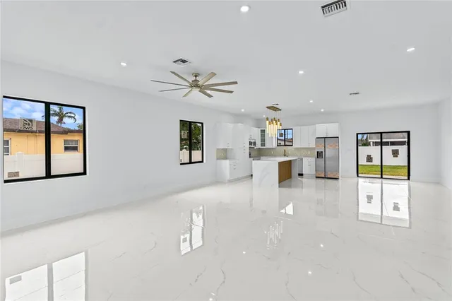 a living room with furniture and kitchen view