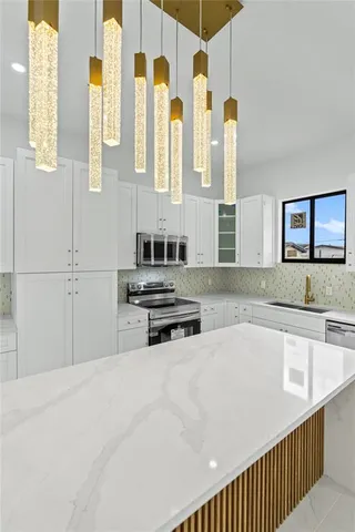 a kitchen with stainless steel appliances a sink and a refrigerator