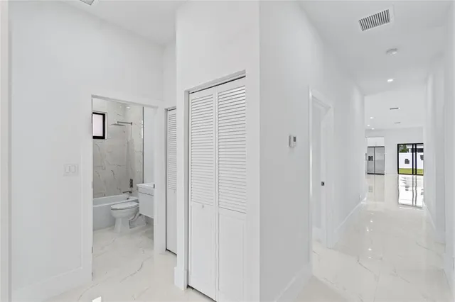 a bathroom with a granite countertop toilet and a shower