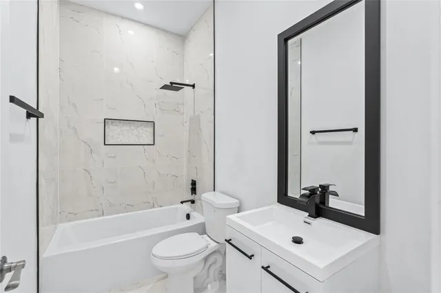 a bathroom with a sink toilet tub and shower