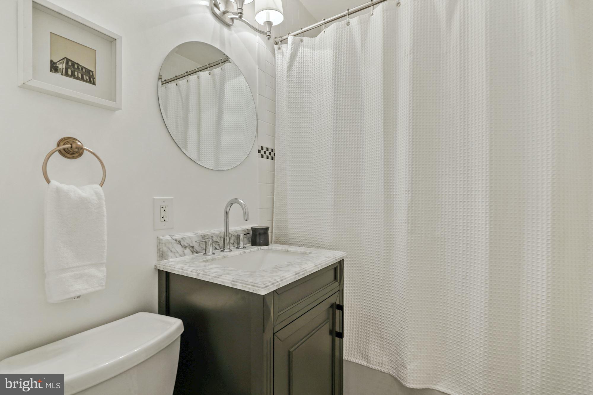 2411 Observatory Place Northwest Washington, DC 20007 - Photo 23 of 45 Primary bedroom with new vanity and light fixture