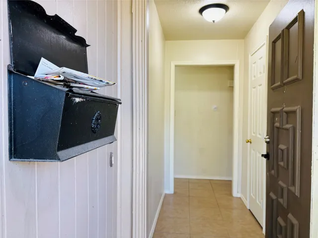 a view of a hallway to rooms