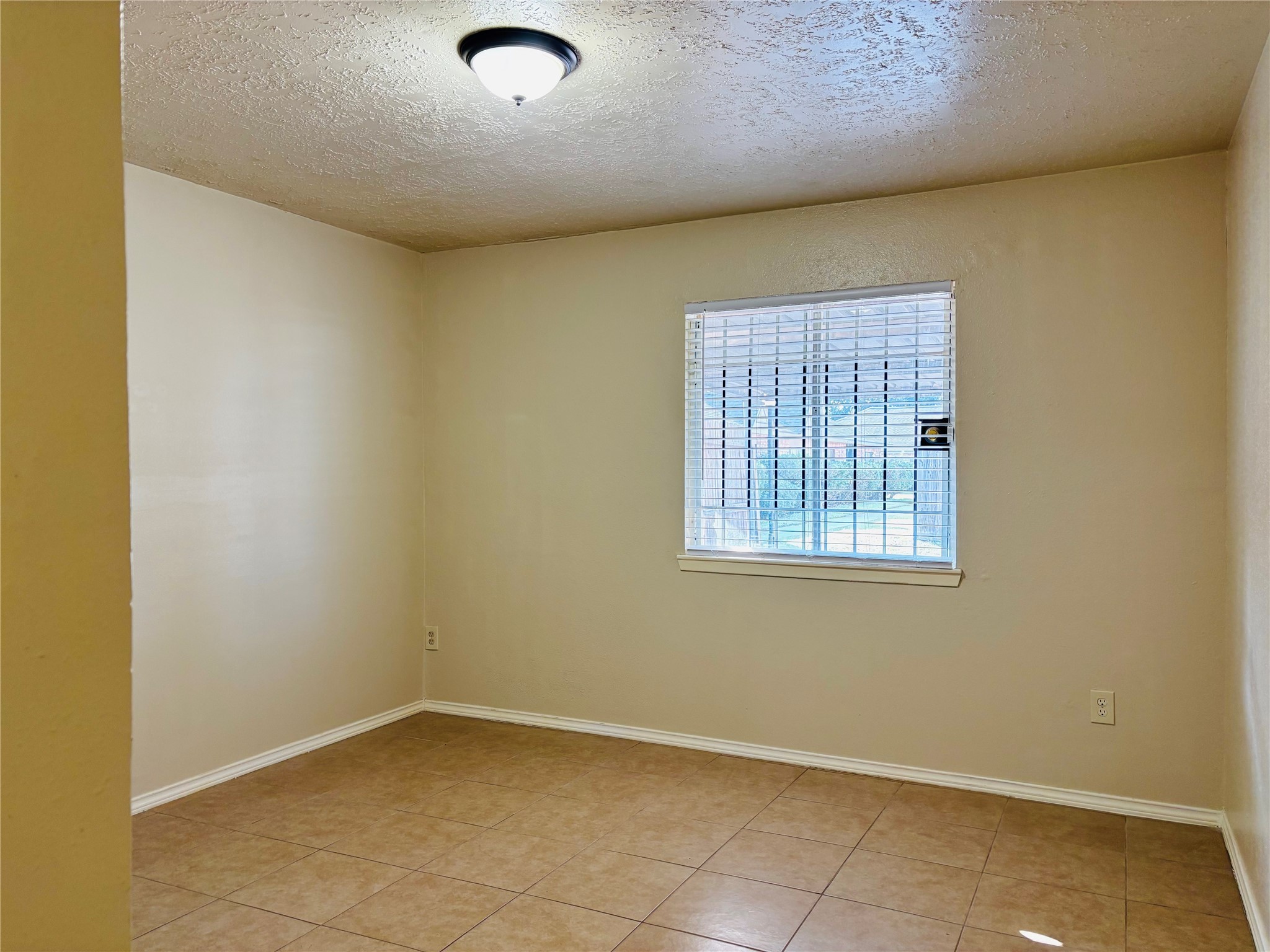 12409 Sharpview Drive, Unit 2409 Houston, TX 77072 - Photo 17 of 21 a view of an empty room with a window
