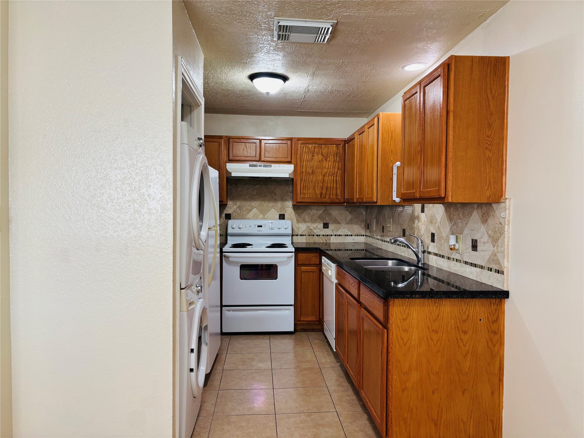 12409 Sharpview Drive, Unit 2409 Houston, TX 77072 - Photo 2 of 21 a kitchen with a stove sink and cabinets