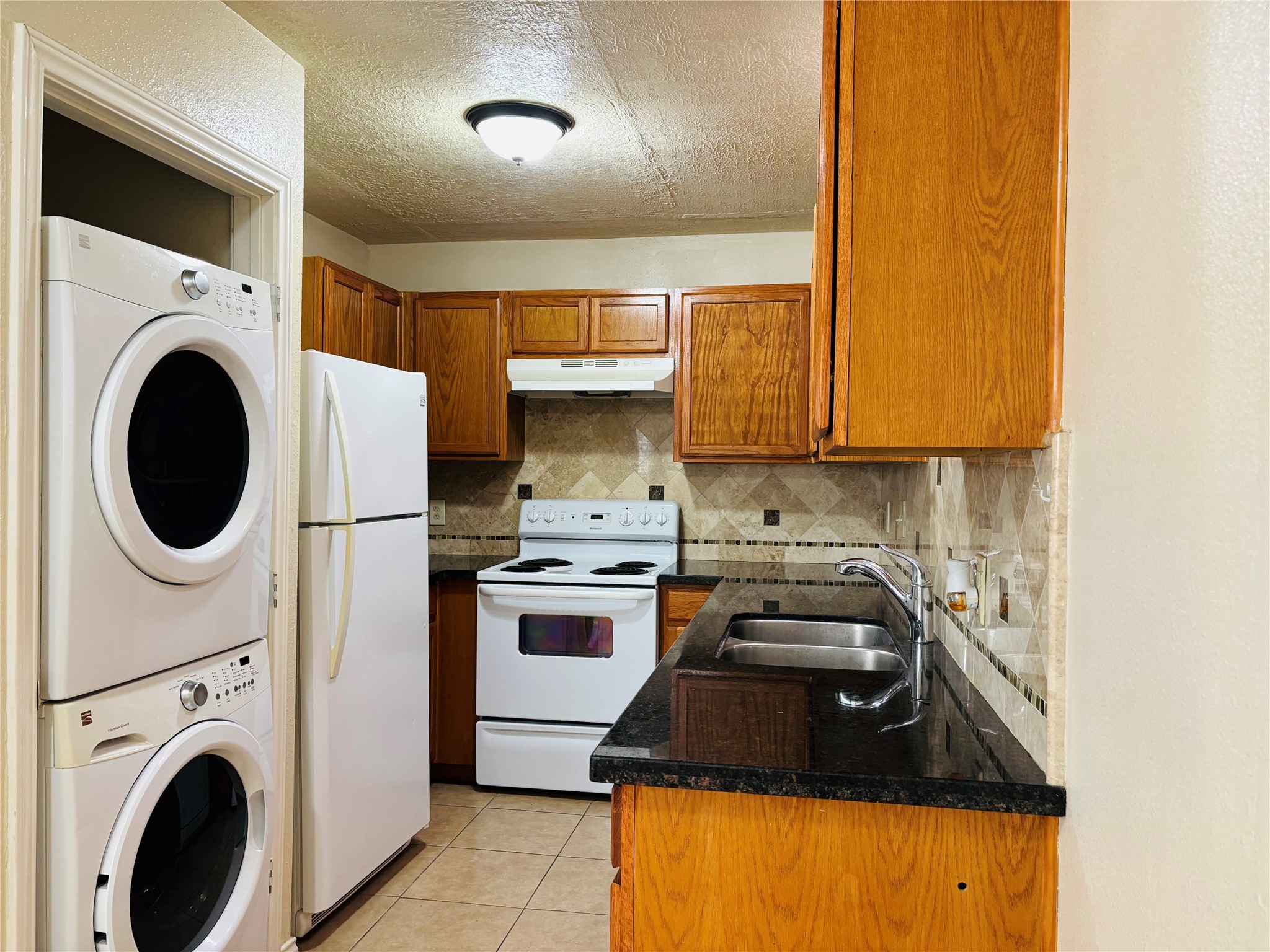 12409 Sharpview Drive, Unit 2409 Houston, TX 77072 - Photo 3 of 21 a kitchen with a sink a stove and cabinets
