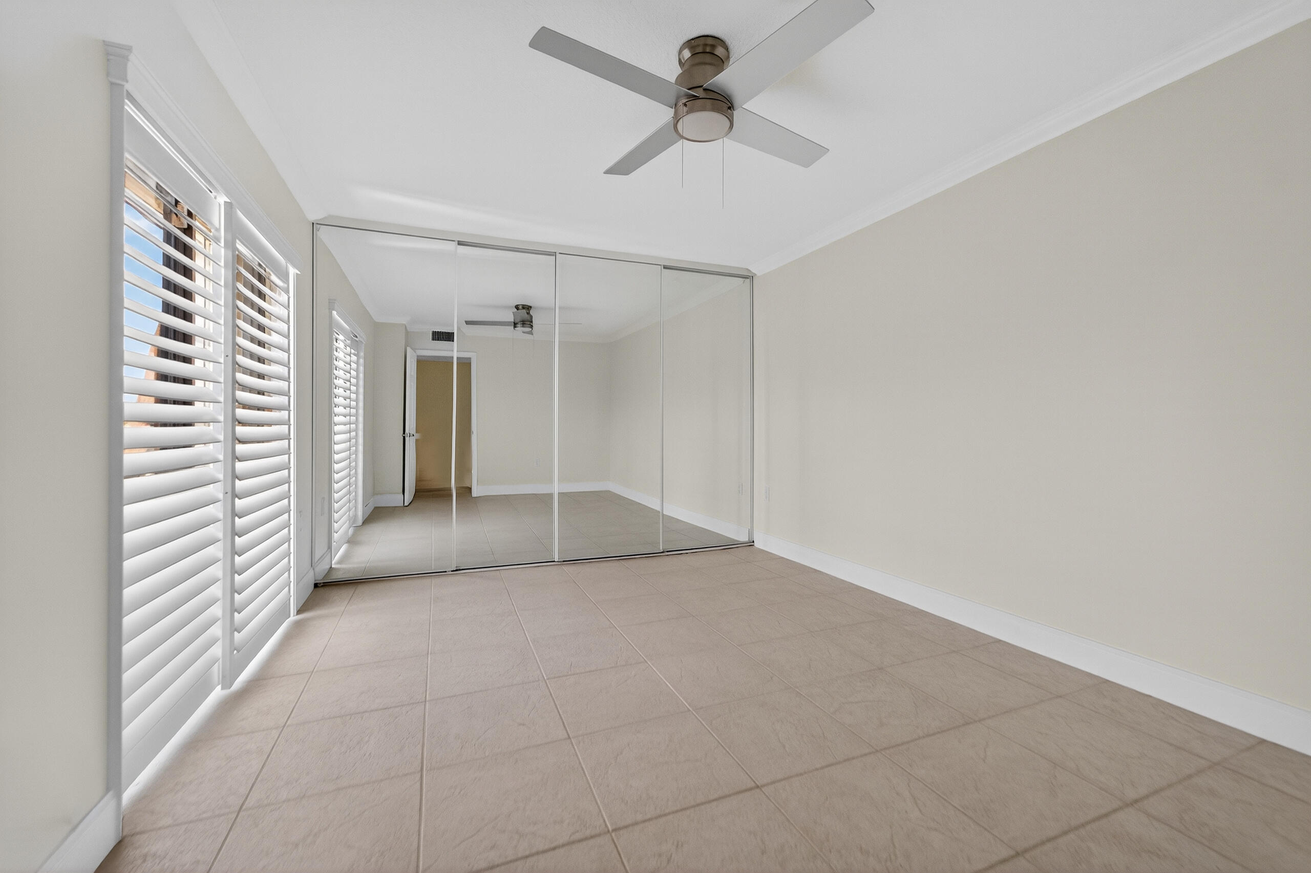 3900 County Line Road, Unit 11D Tequesta, FL 33469 - Photo 25 of 53 a view of a hallway with a chandelier fan and windows