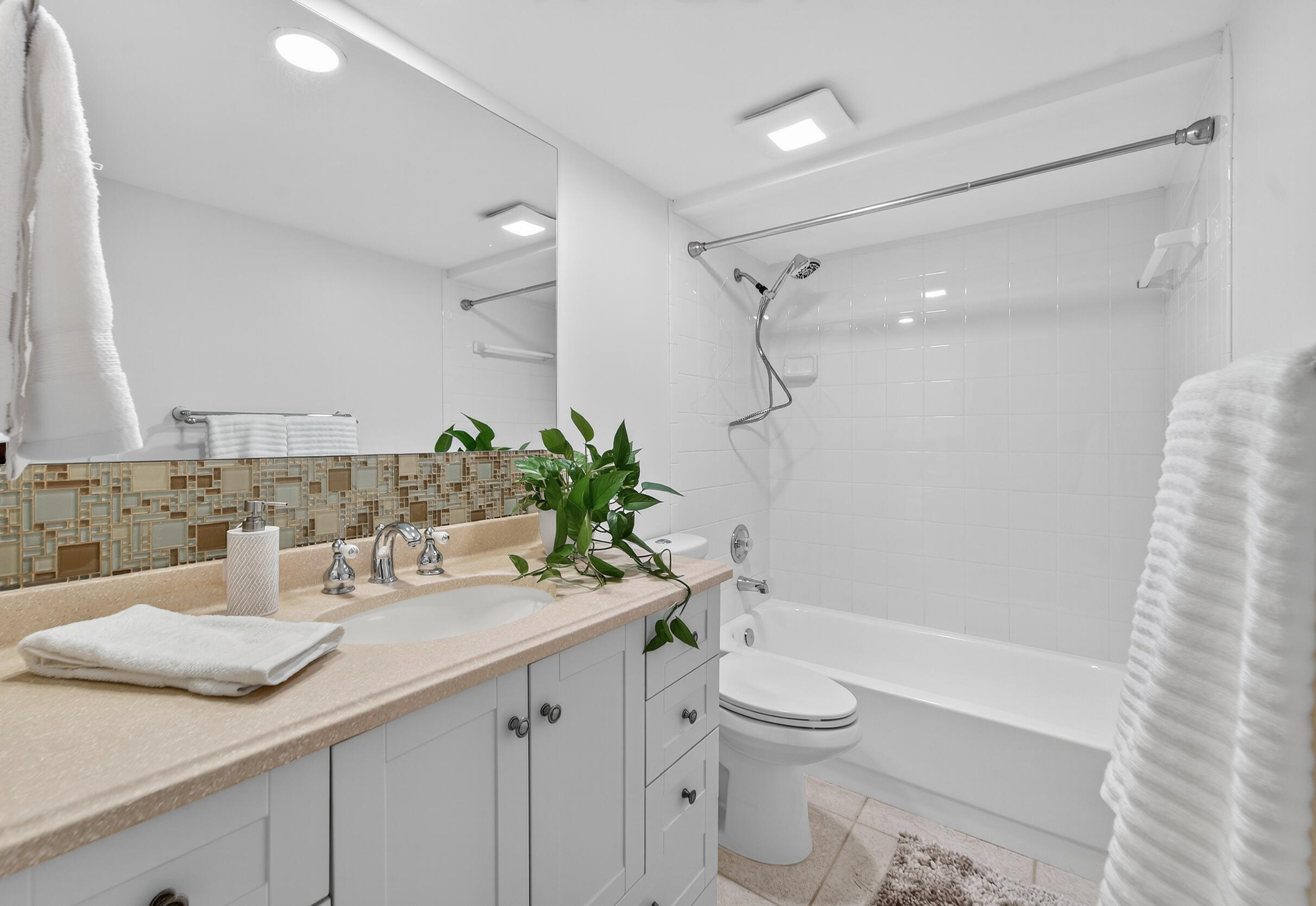 3900 County Line Road, Unit 11D Tequesta, FL 33469 - Photo 28 of 53 a bathroom with a sink a toilet and shower