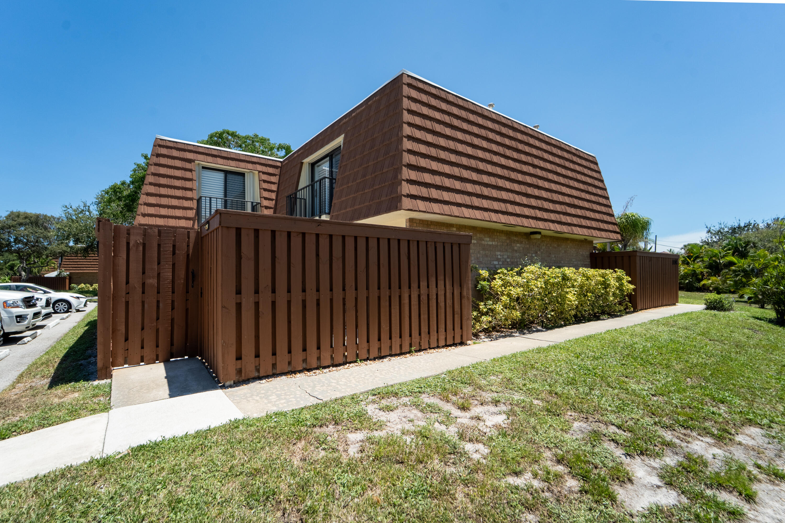 3900 County Line Road, Unit 11D Tequesta, FL 33469 - Photo 36 of 53 a front view of a house with a yard