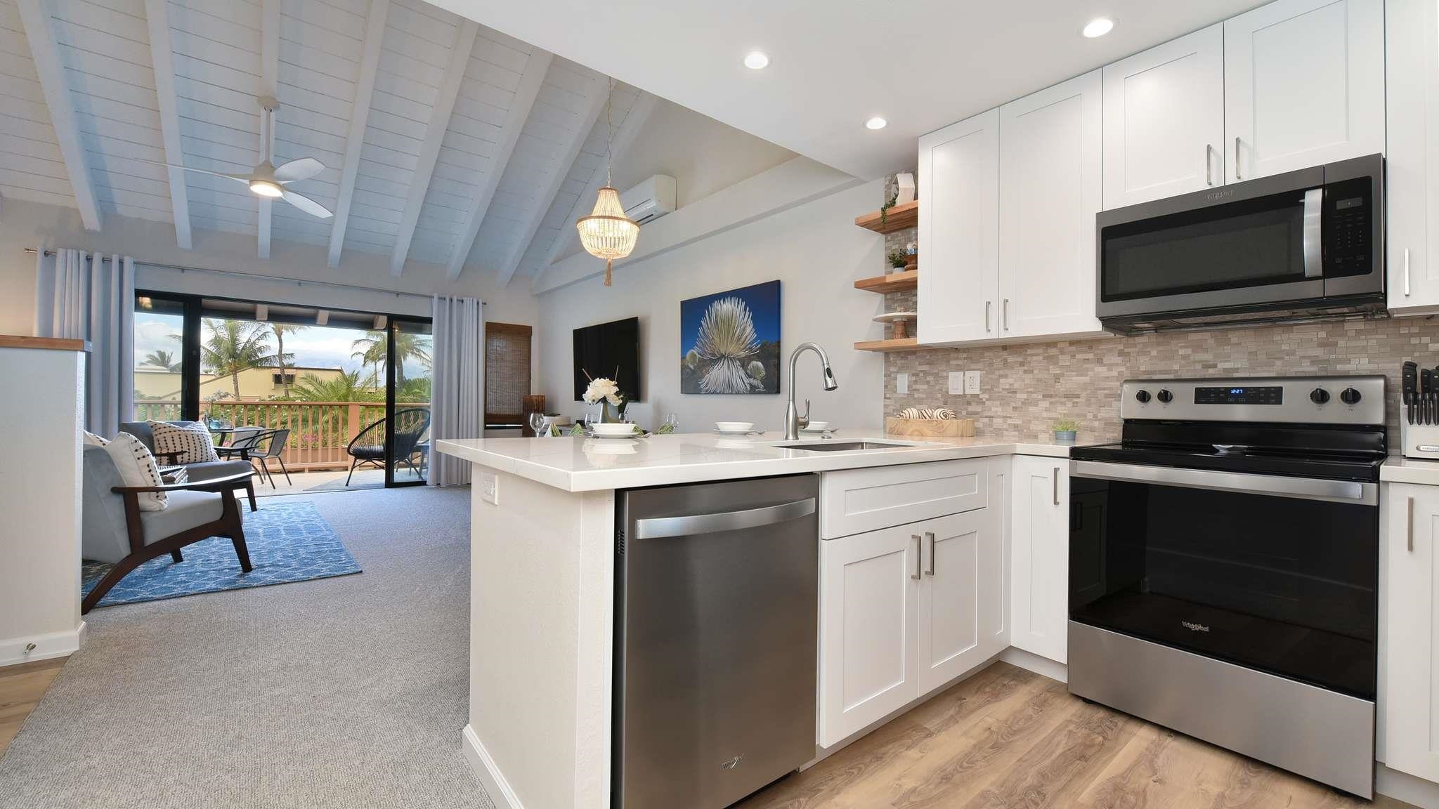 2777 South Kihei Road, Unit E202 Kihei, HI 96753 - Photo 11 of 37 a kitchen with a sink stainless steel appliances and cabinets