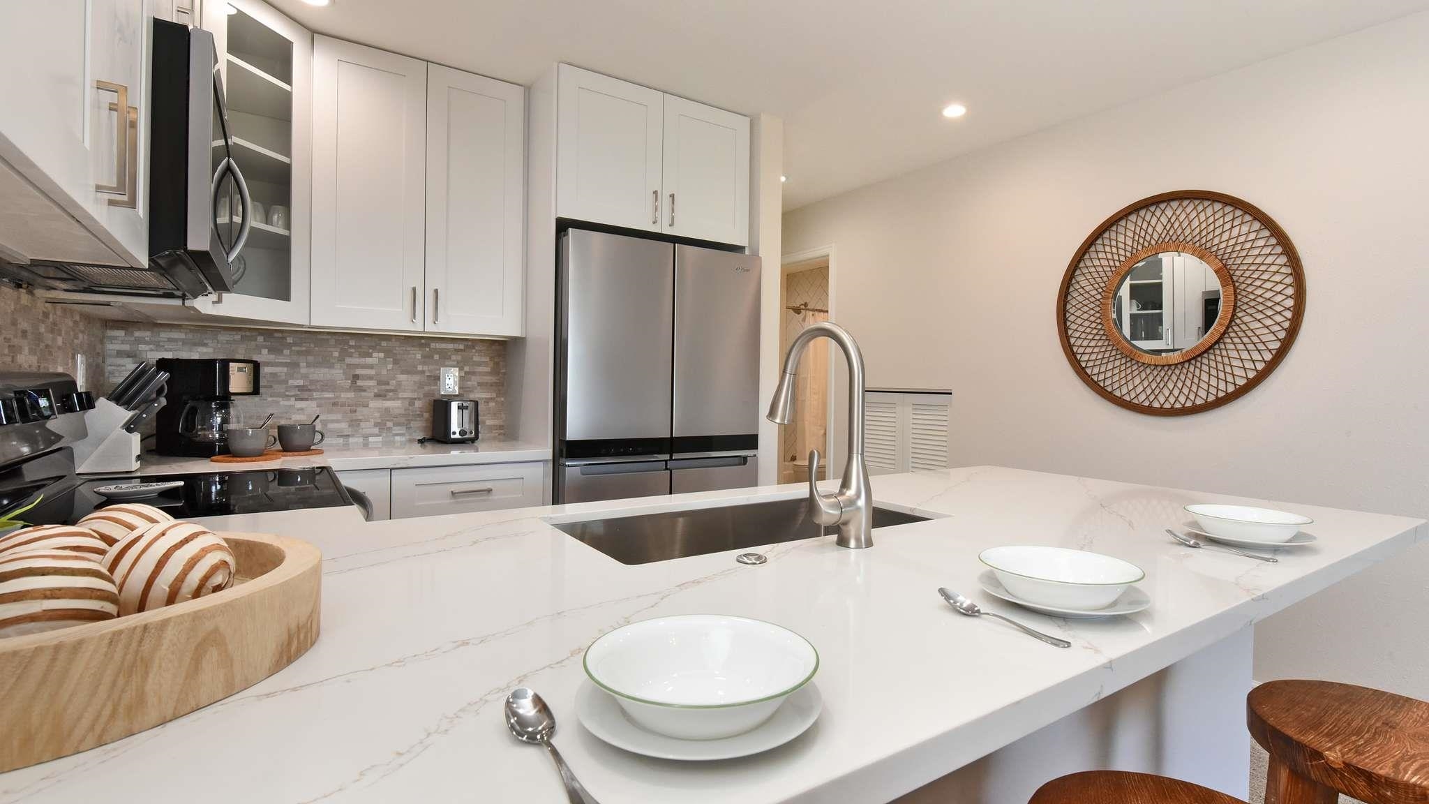 2777 South Kihei Road, Unit E202 Kihei, HI 96753 - Photo 13 of 37 a kitchen with stainless steel appliances granite countertop a dining table and chairs