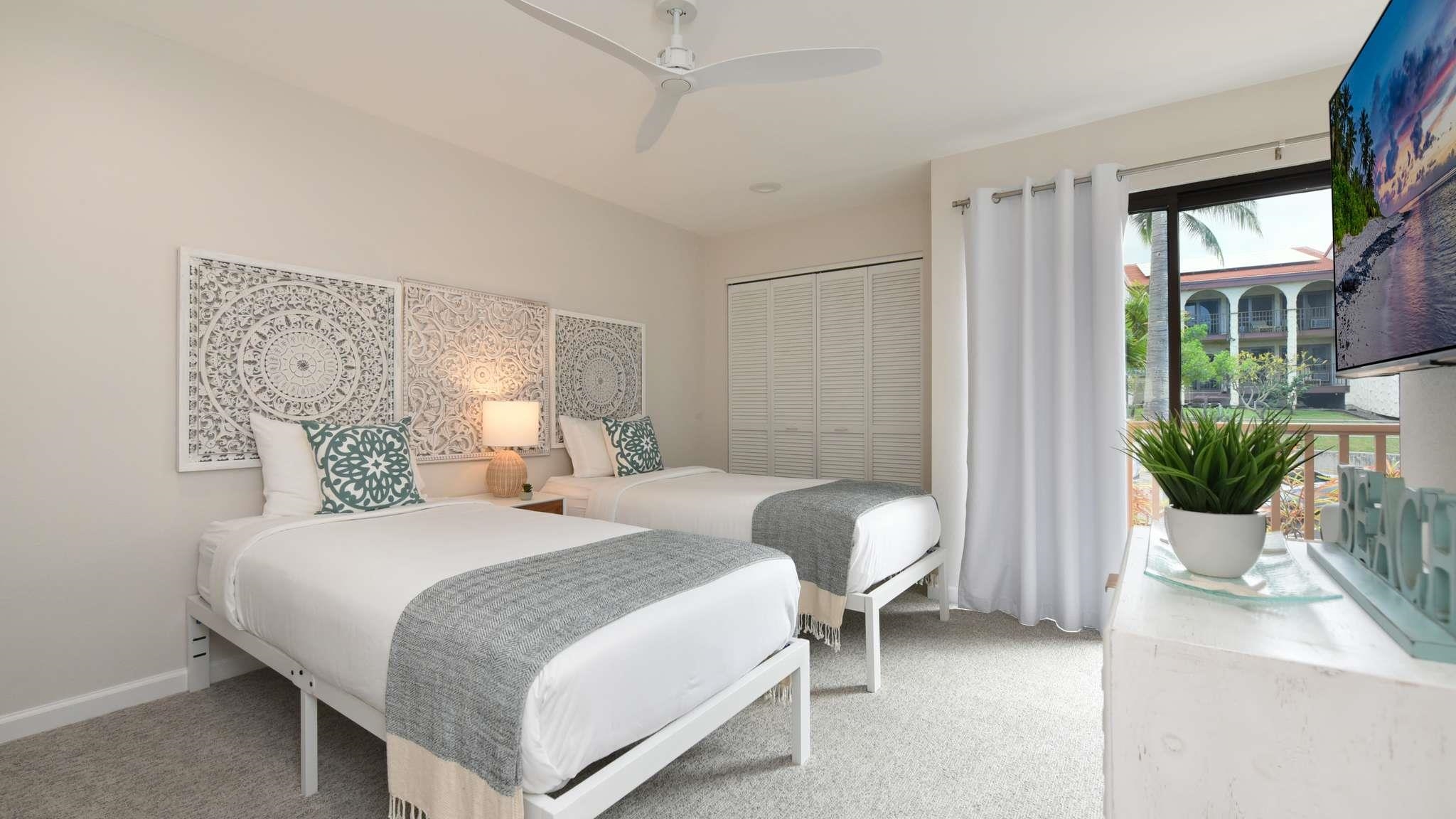 2777 South Kihei Road, Unit E202 Kihei, HI 96753 - Photo 18 of 37 a bedroom with a bed and a potted plant