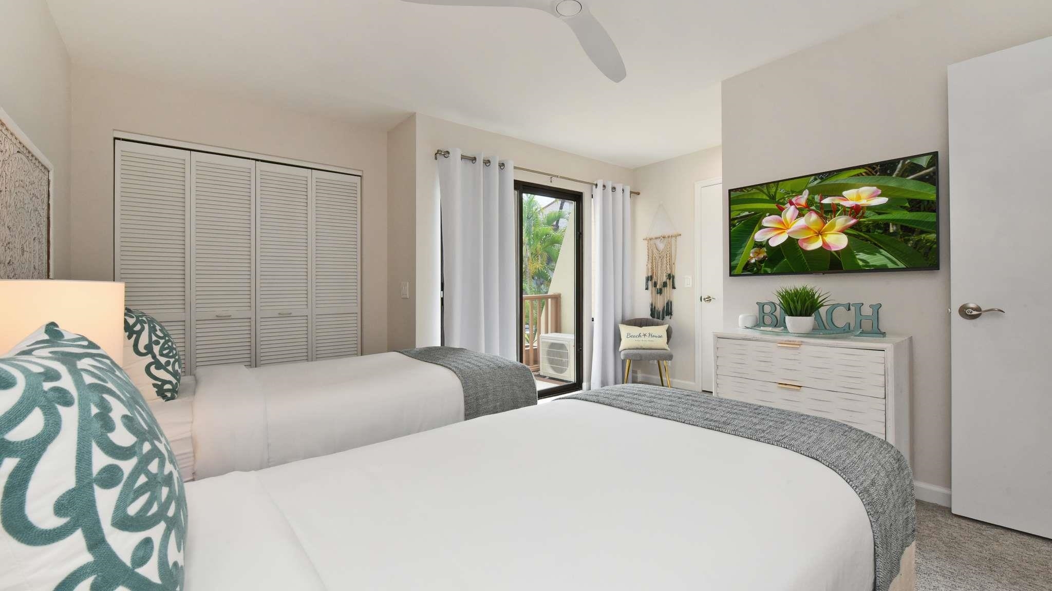 2777 South Kihei Road, Unit E202 Kihei, HI 96753 - Photo 19 of 37 a bedroom with two beds and a flat screen tv