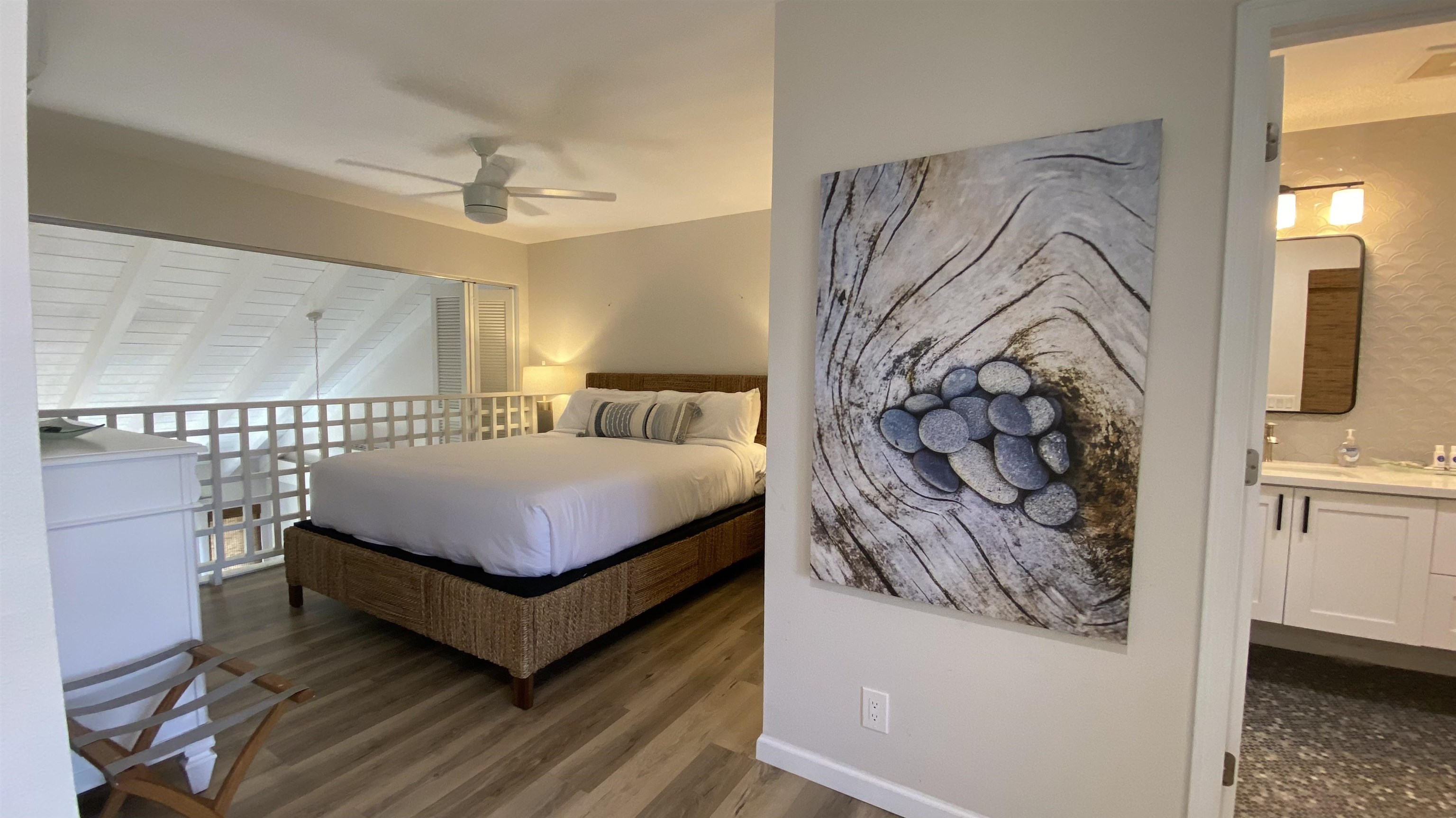 2777 South Kihei Road, Unit E202 Kihei, HI 96753 - Photo 28 of 37 a bedroom with a bed and wooden floor