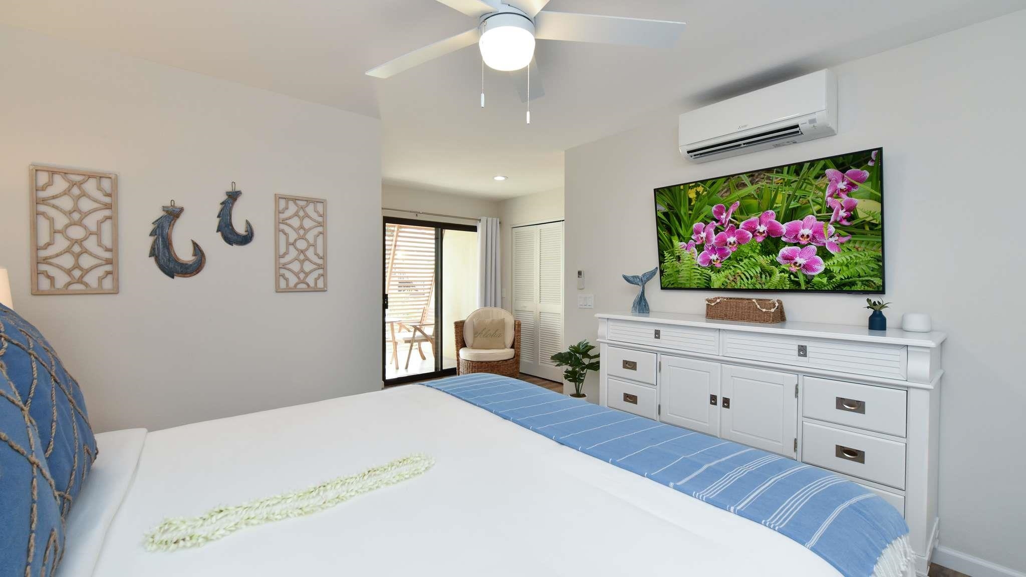 2777 South Kihei Road, Unit E202 Kihei, HI 96753 - Photo 31 of 37 a bedroom with a bed and a flat screen tv