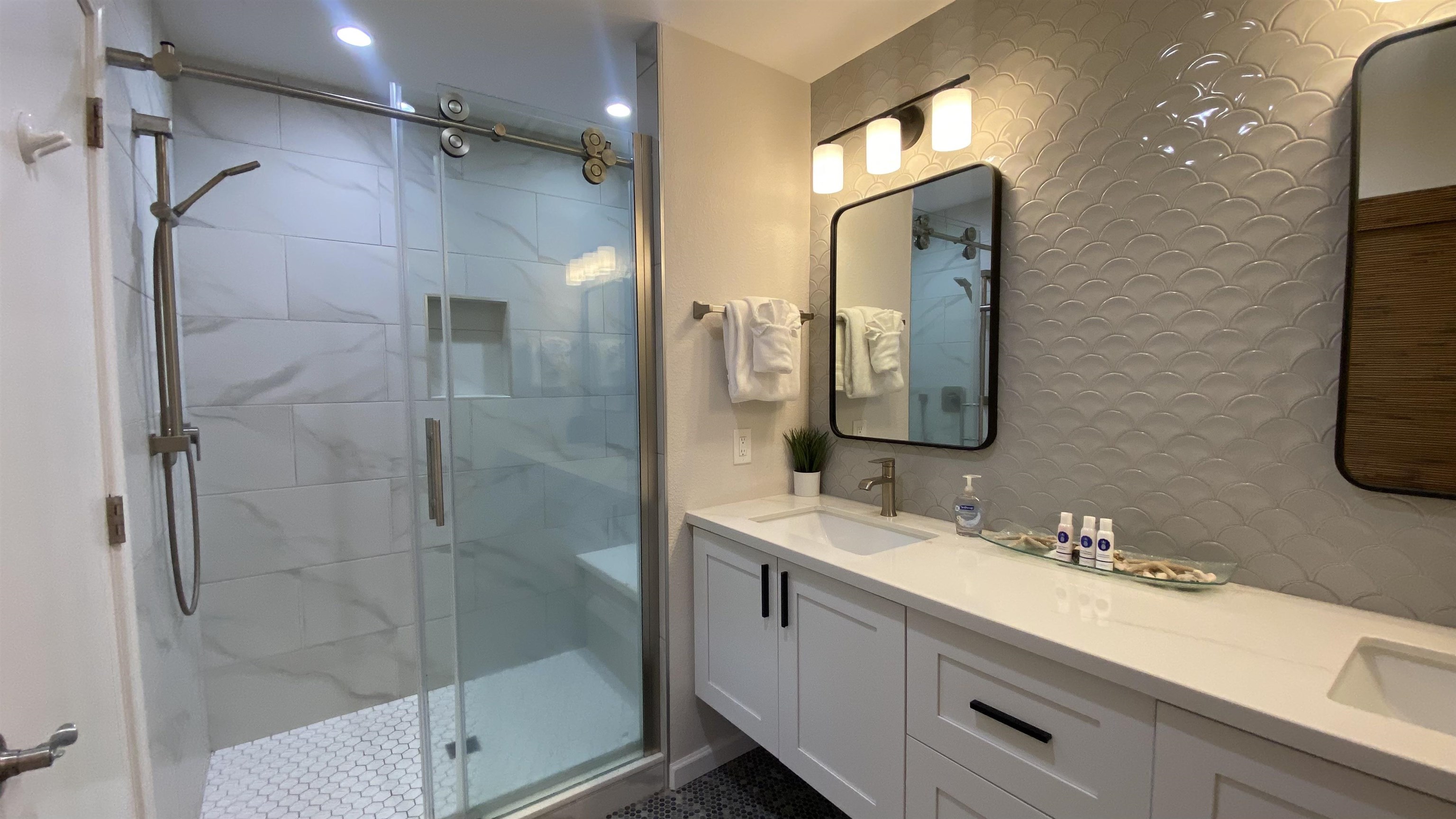 2777 South Kihei Road, Unit E202 Kihei, HI 96753 - Photo 33 of 37 a bathroom with a double vanity sink mirror and shower