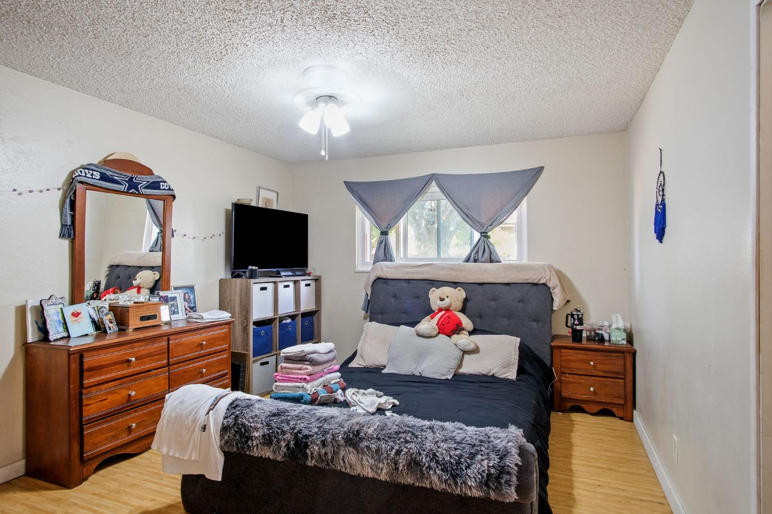 3221 Dublin Avenue Merced, CA 95340 - Photo 16 of 22 a bedroom with furniture and a flat screen tv