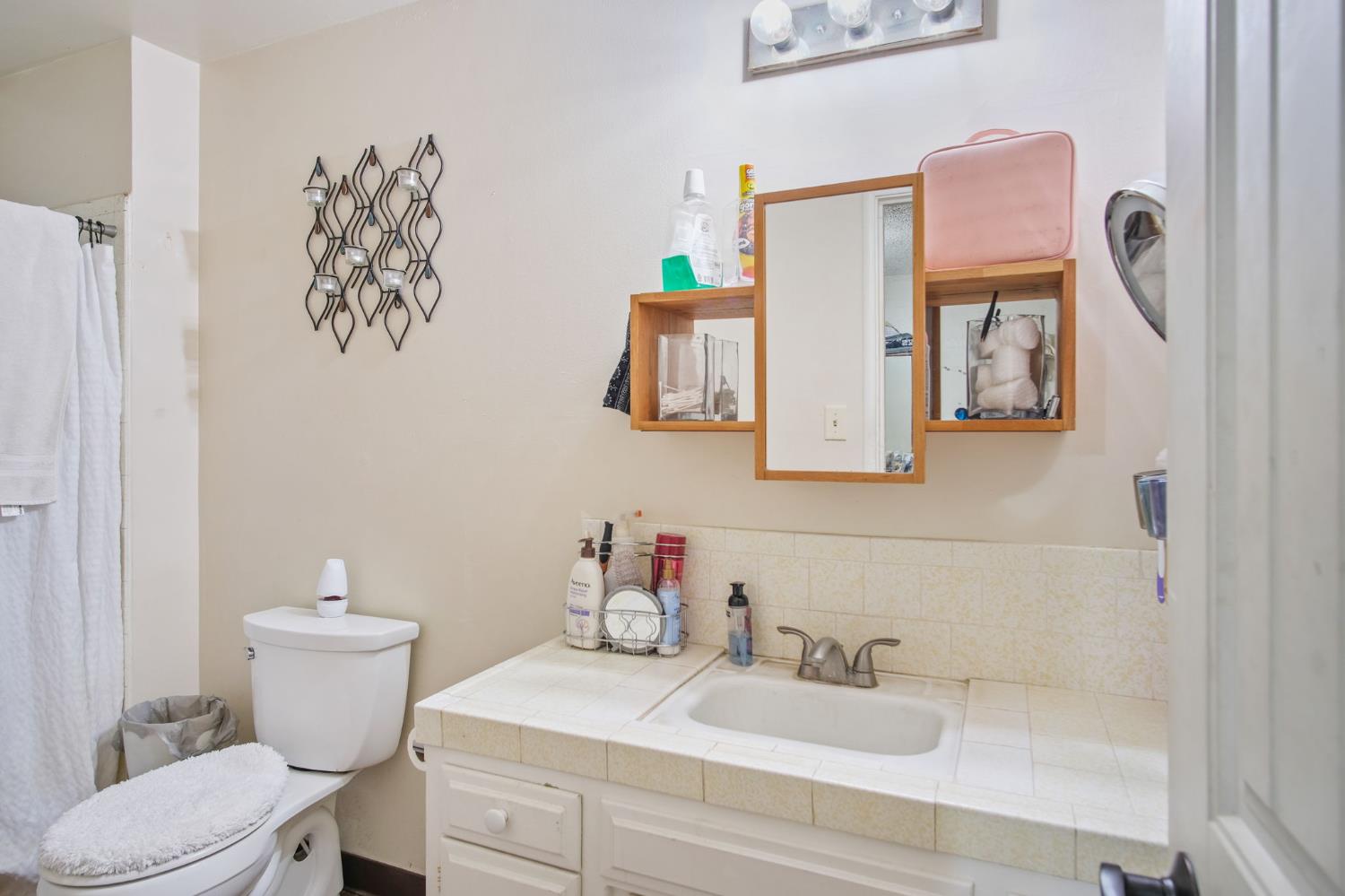 3221 Dublin Avenue Merced, CA 95340 - Photo 18 of 22 a bathroom with a sink mirror and toilet