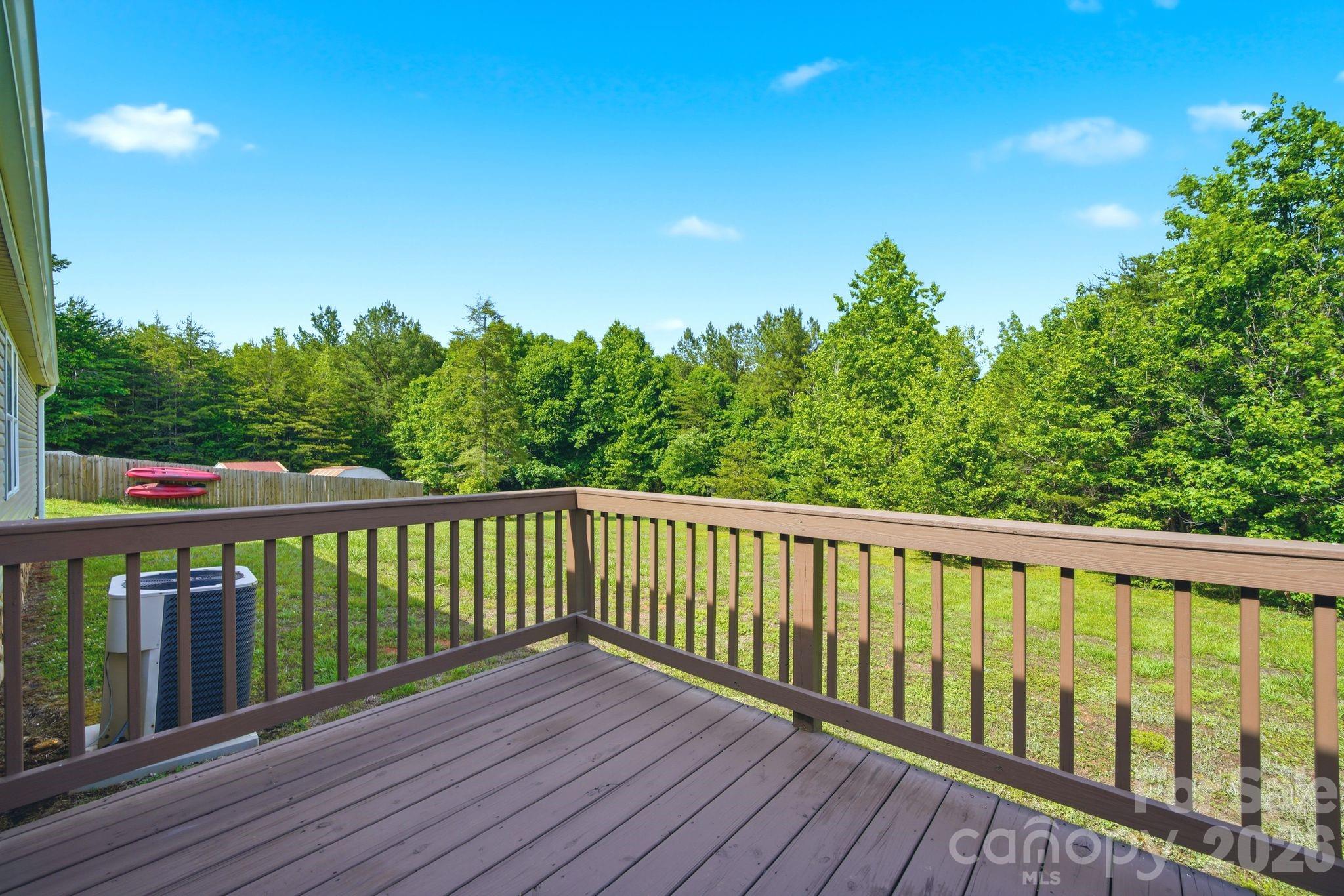 2368 Beth Haven Church Road Denver, NC 28037 - Photo 36 of 42 a balcony with wooden floor and trees in the background