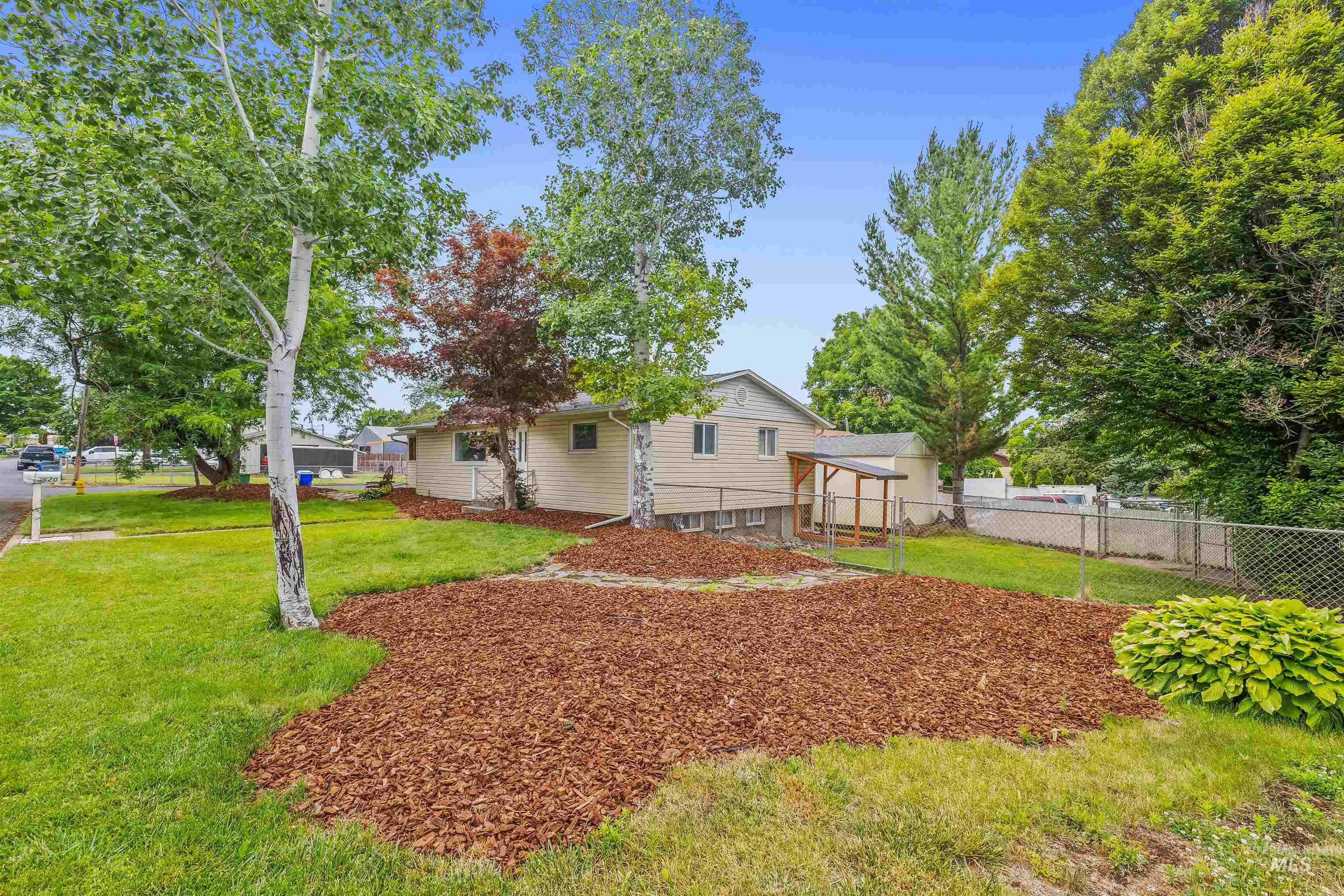 3620 18th Street Lewiston, ID 83501 - Photo 32 of 32 Landscaped front yard featuring mature trees and a mulched bed