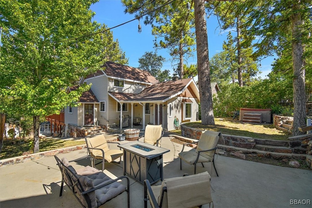 667 Talmadge Road Big Bear Lake, CA 92315 - Photo 1 of 41 a view of a patio with table and chairs and floor to ceiling window