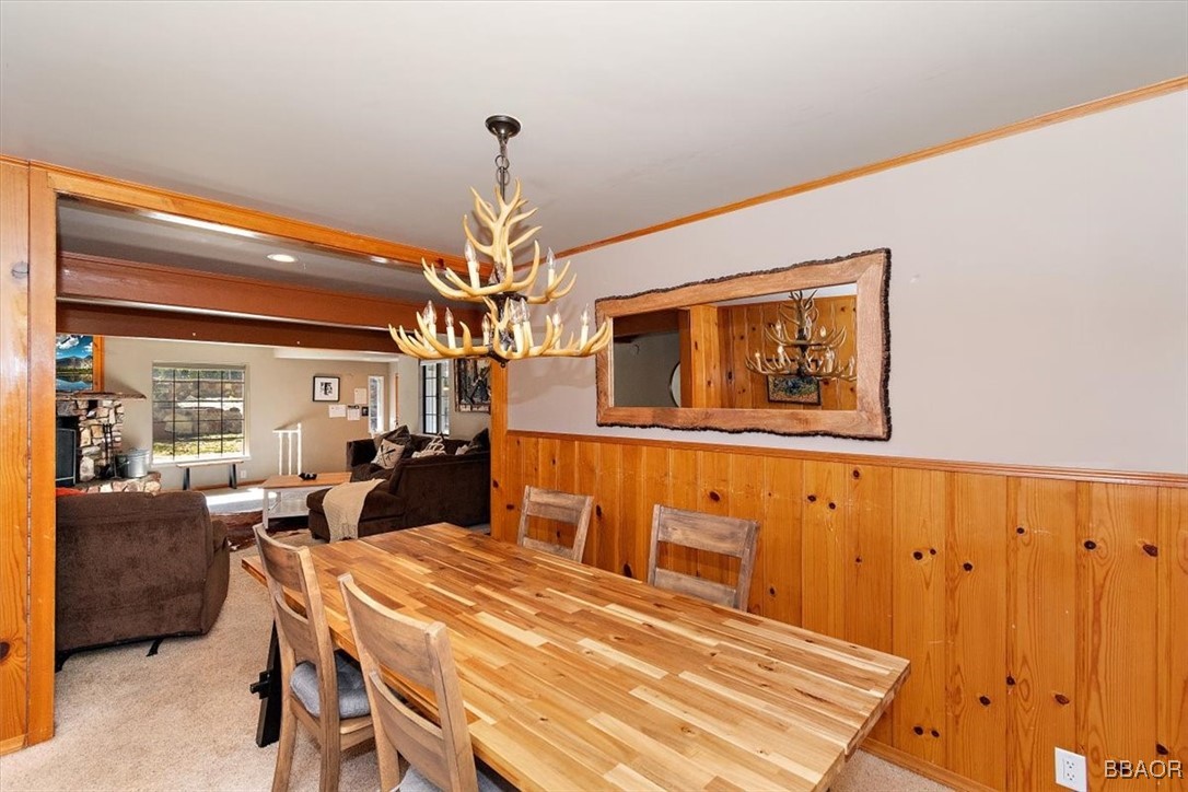 667 Talmadge Road Big Bear Lake, CA 92315 - Photo 14 of 41 a dining room with wooden floor a chandelier fan a wooden table and chairs