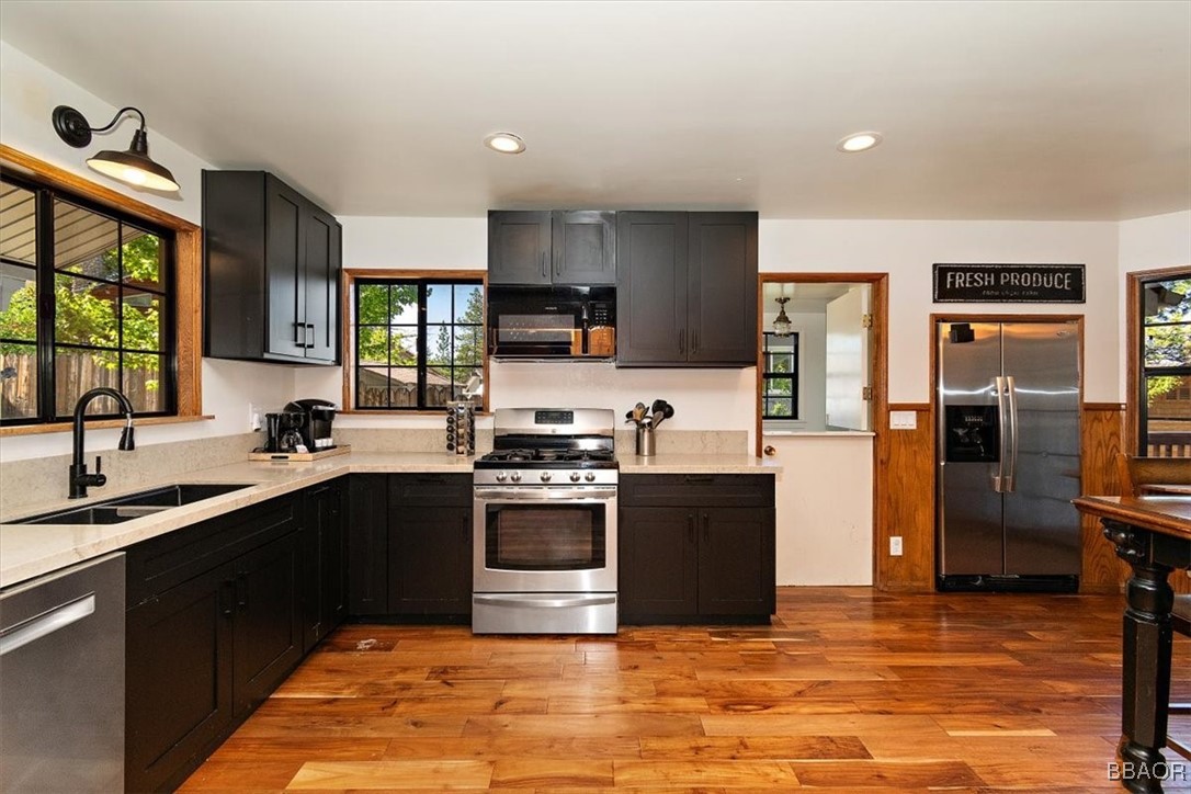 667 Talmadge Road Big Bear Lake, CA 92315 - Photo 15 of 41 a kitchen with stainless steel appliances granite countertop a sink dishwasher stove top oven and refrigerator
