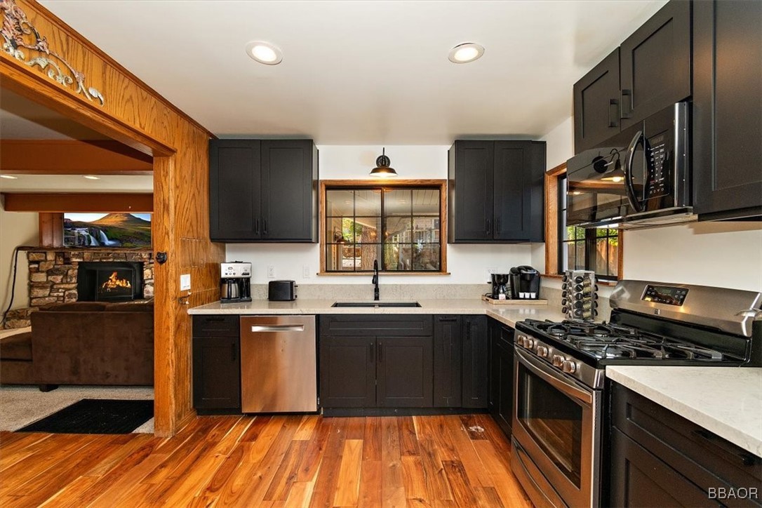 667 Talmadge Road Big Bear Lake, CA 92315 - Photo 16 of 41 a kitchen with stainless steel appliances granite countertop a sink stove and refrigerator
