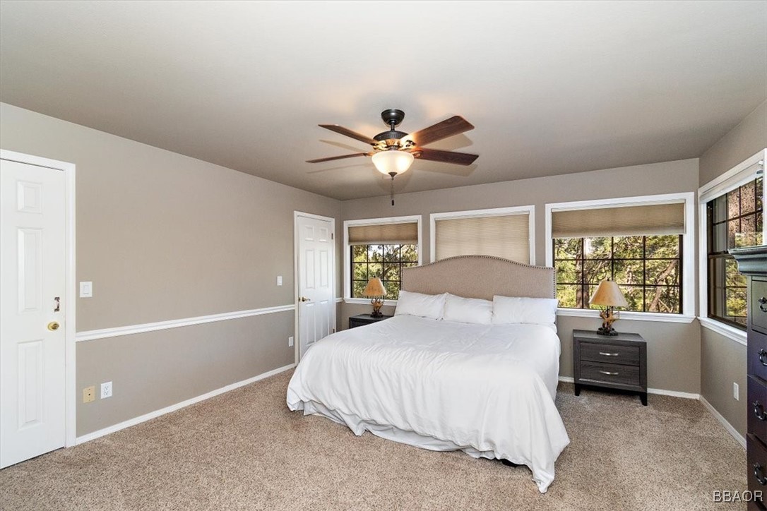 667 Talmadge Road Big Bear Lake, CA 92315 - Photo 21 of 41 a bedroom with a large bed chandelier and a window