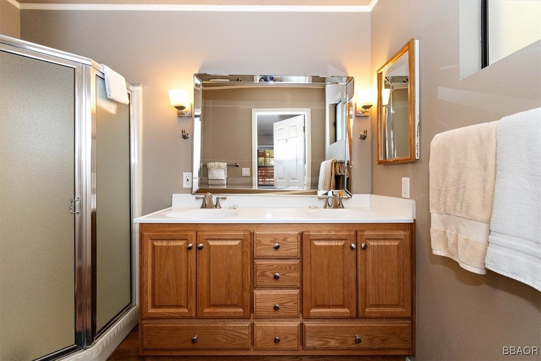 667 Talmadge Road Big Bear Lake, CA 92315 - Photo 24 of 41 a bathroom with a granite countertop sink and a mirror