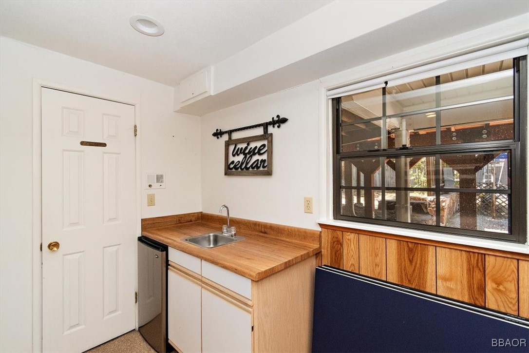 667 Talmadge Road Big Bear Lake, CA 92315 - Photo 28 of 41 a kitchen with a sink and a refrigerator