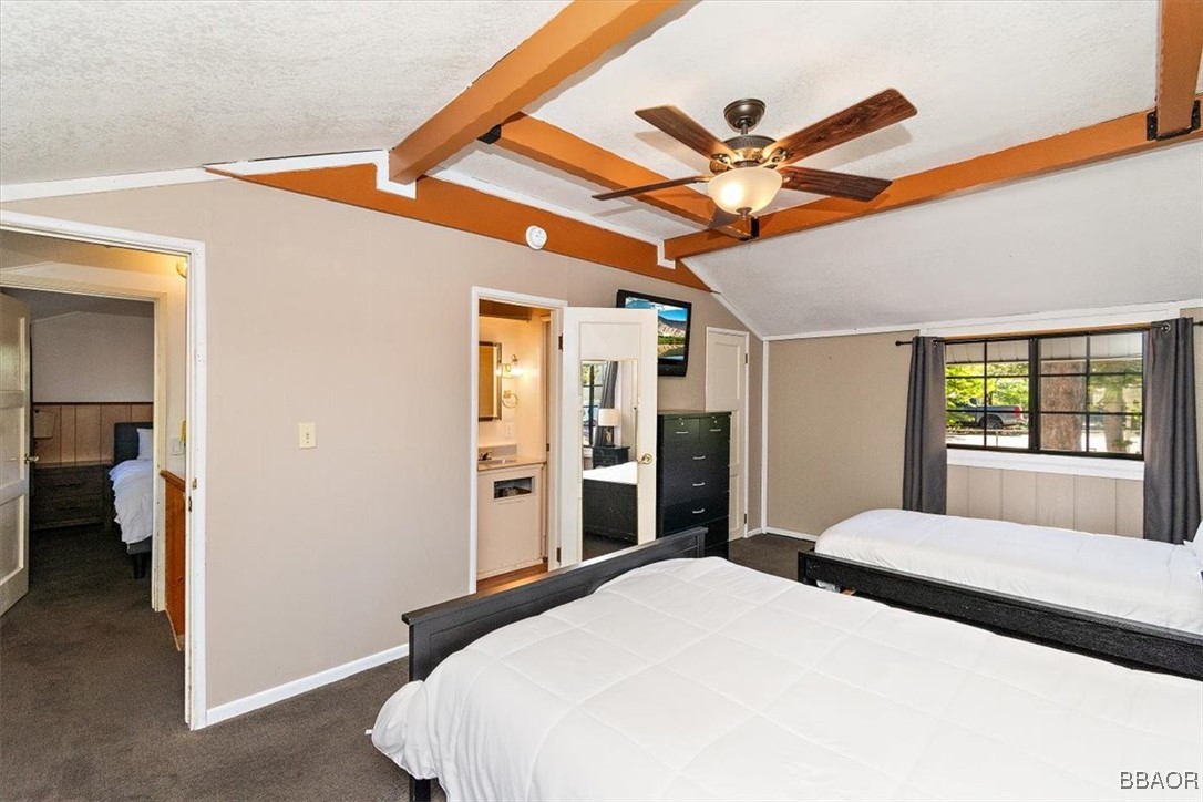 667 Talmadge Road Big Bear Lake, CA 92315 - Photo 38 of 41 a bedroom with a bed and a chandelier