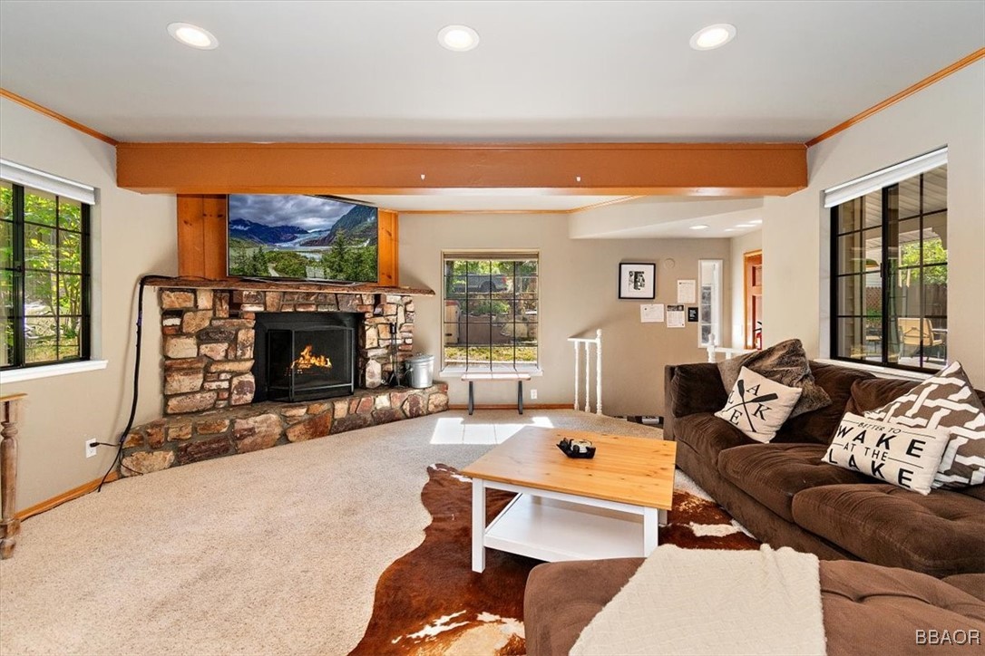 667 Talmadge Road Big Bear Lake, CA 92315 - Photo 9 of 41 a living room with furniture a fireplace and a flat screen tv