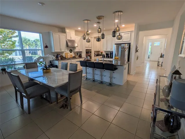 a view of a dining room with furniture and a chandelier