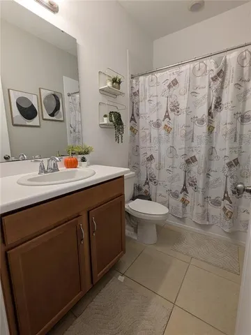 a bathroom with a double vanity sink toilet and a mirror