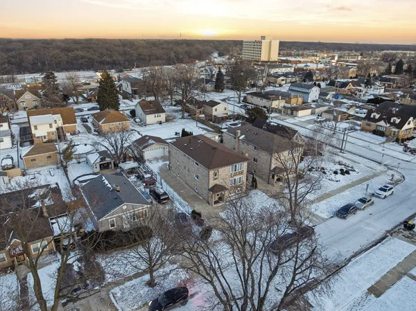 an aerial view of residential houses with city view