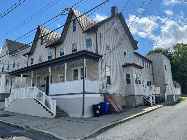 a kitchen with granite countertop white cabinets and a sink
