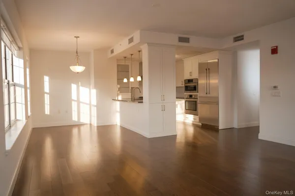 a living room with furniture and large windows