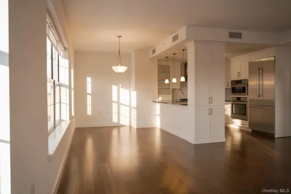 a view of a room with window and wooden floor
