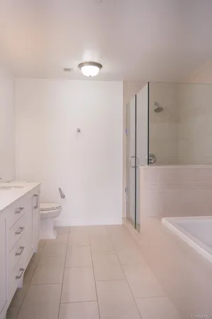 a bathroom with a granite countertop sink a toilet and a mirror