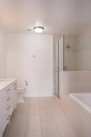 a bathroom with a granite countertop sink a toilet and a mirror
