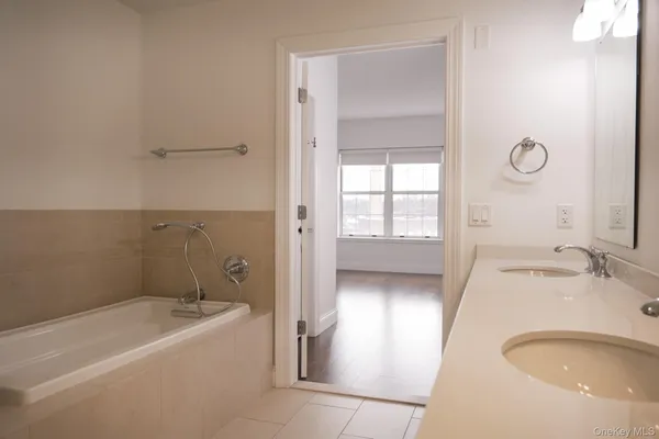 a bathroom with a granite countertop sink a toilet and a bathtub